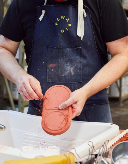 Artisan glazing a candle tray