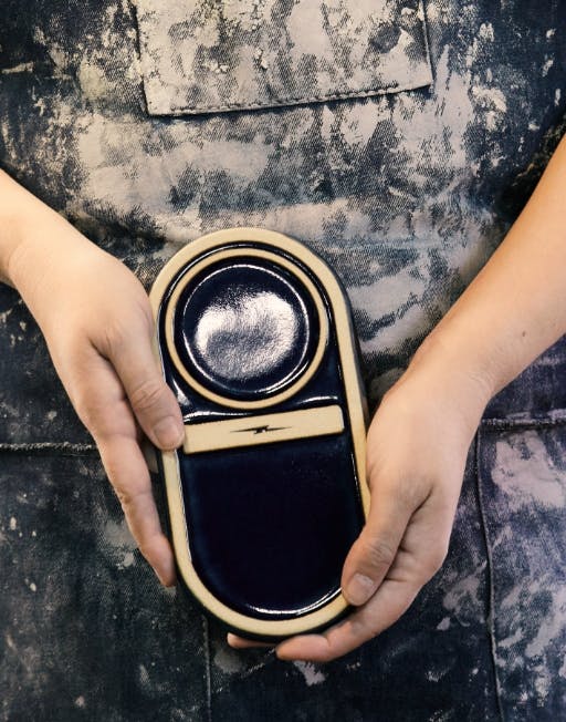 Artisan holding a candle tray