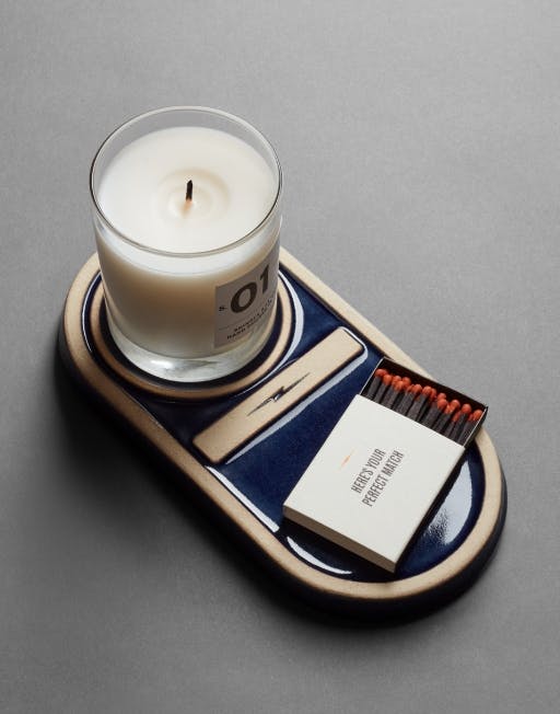 Shinola X Pewabic candle tray with Shinola candle and matches resting on it