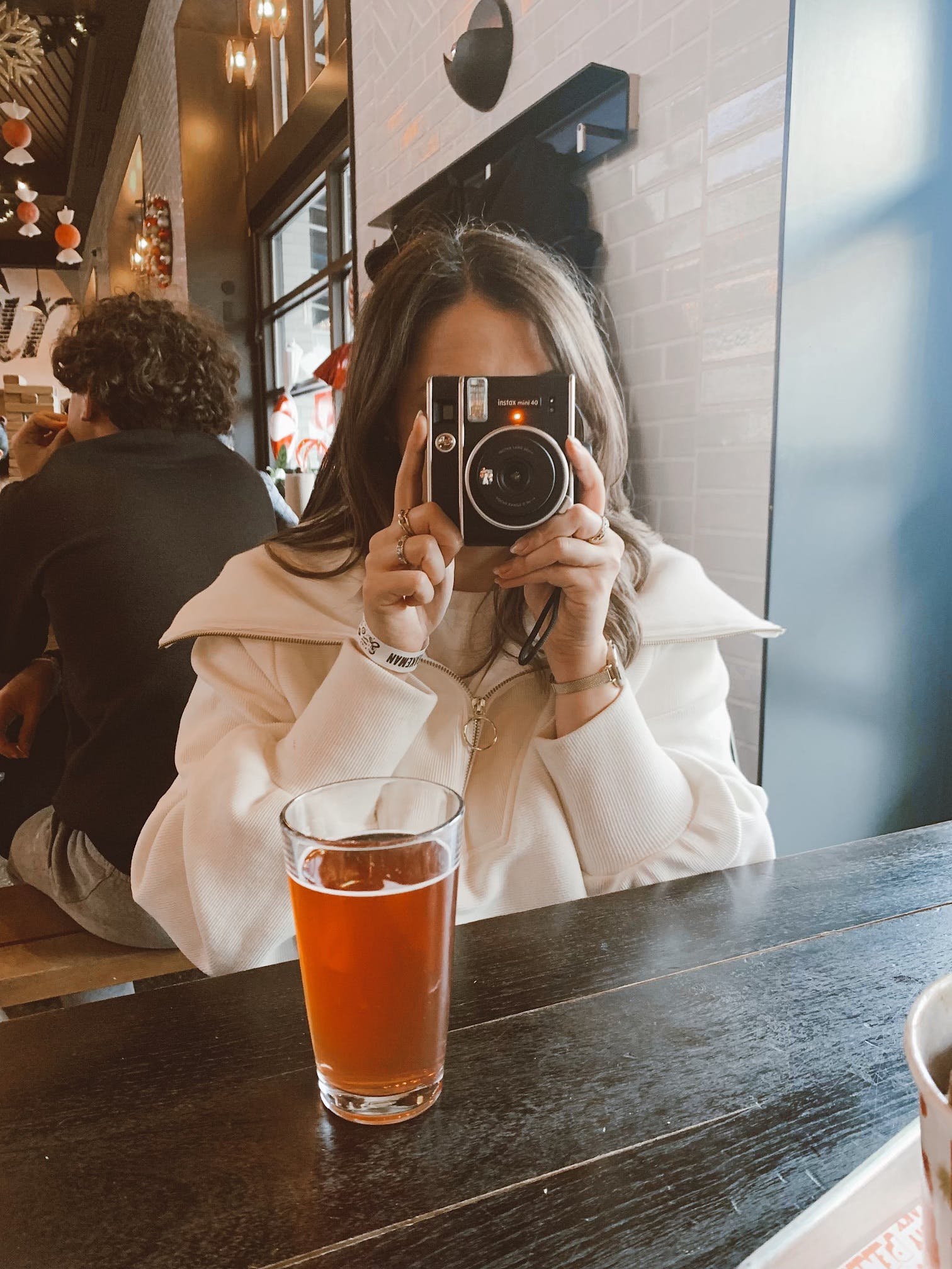 Author photo of Sarah Waldrop holding a Polaroid camera